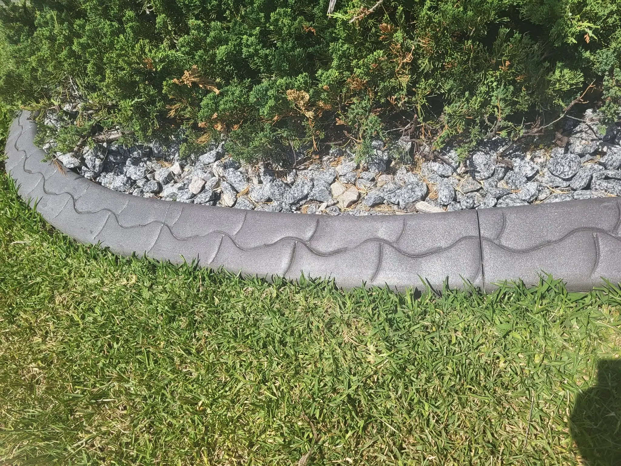 Decorative concrete landscape curbing around a garden bed